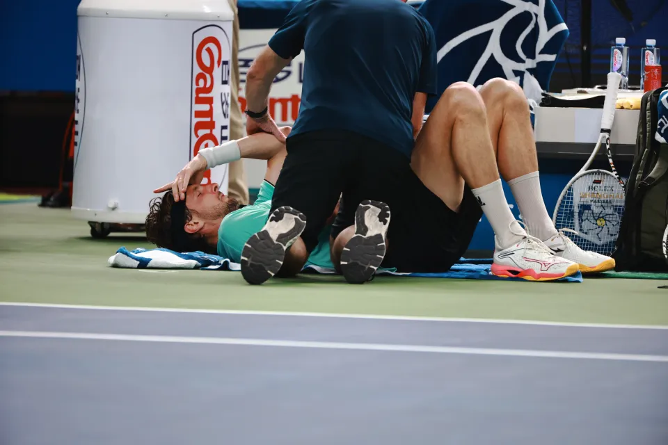 Arthur Rinderknech of France receives medical treatment on the tennis court.