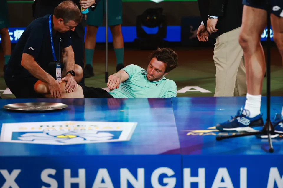 Arthur Rinderknech of France receives medical treatment after his Men's Singles Final loss at the Shanghai Masters tennis tournament.
