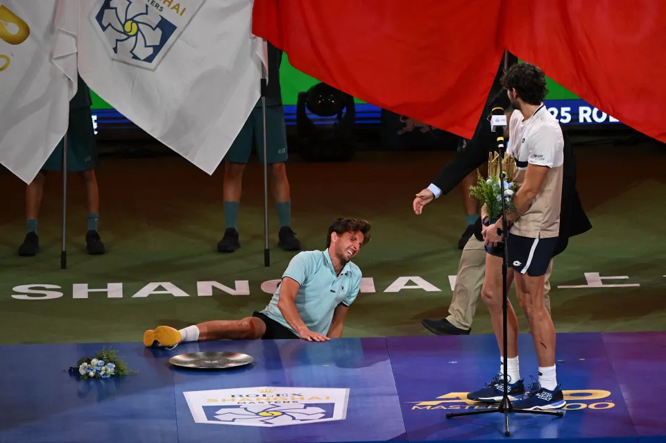 Runner-up Arthur Rinderknech reacts as Valentin Vacherot delivers a speech during the awards ceremony.