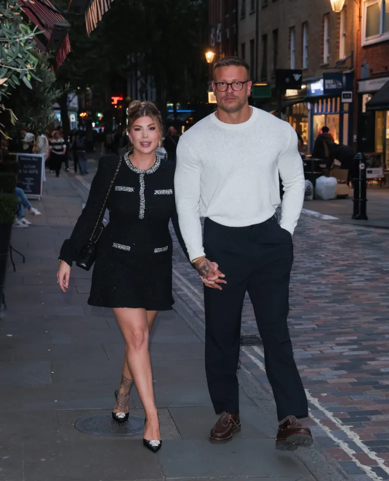 Olivia and Alex Bowen walking hand-in-hand at the screening of their new series, "Olivia and Alex: Parenthood".