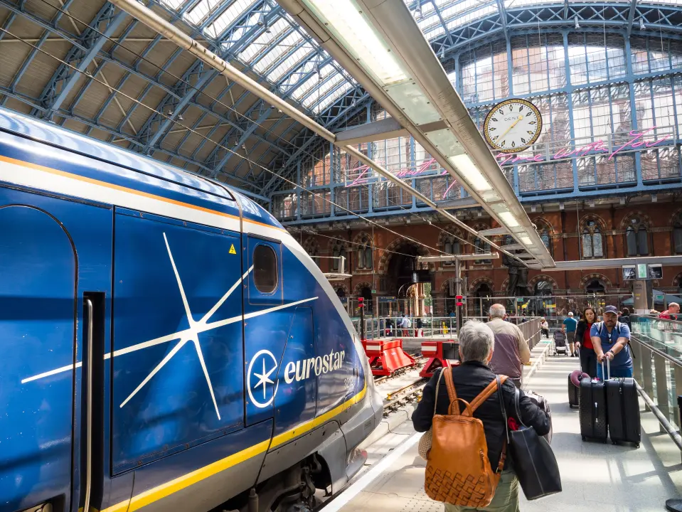 Eurostar train at London St Pancras International station, with passengers on the platform.