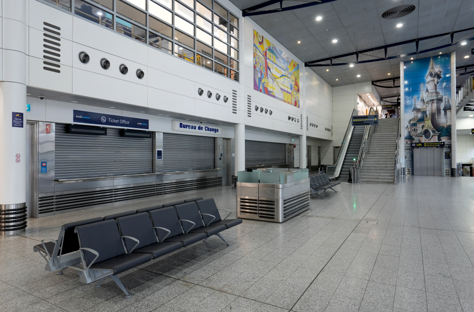 Main entrance of Ashford International station with closed ticket office and Bureau de Change counters.