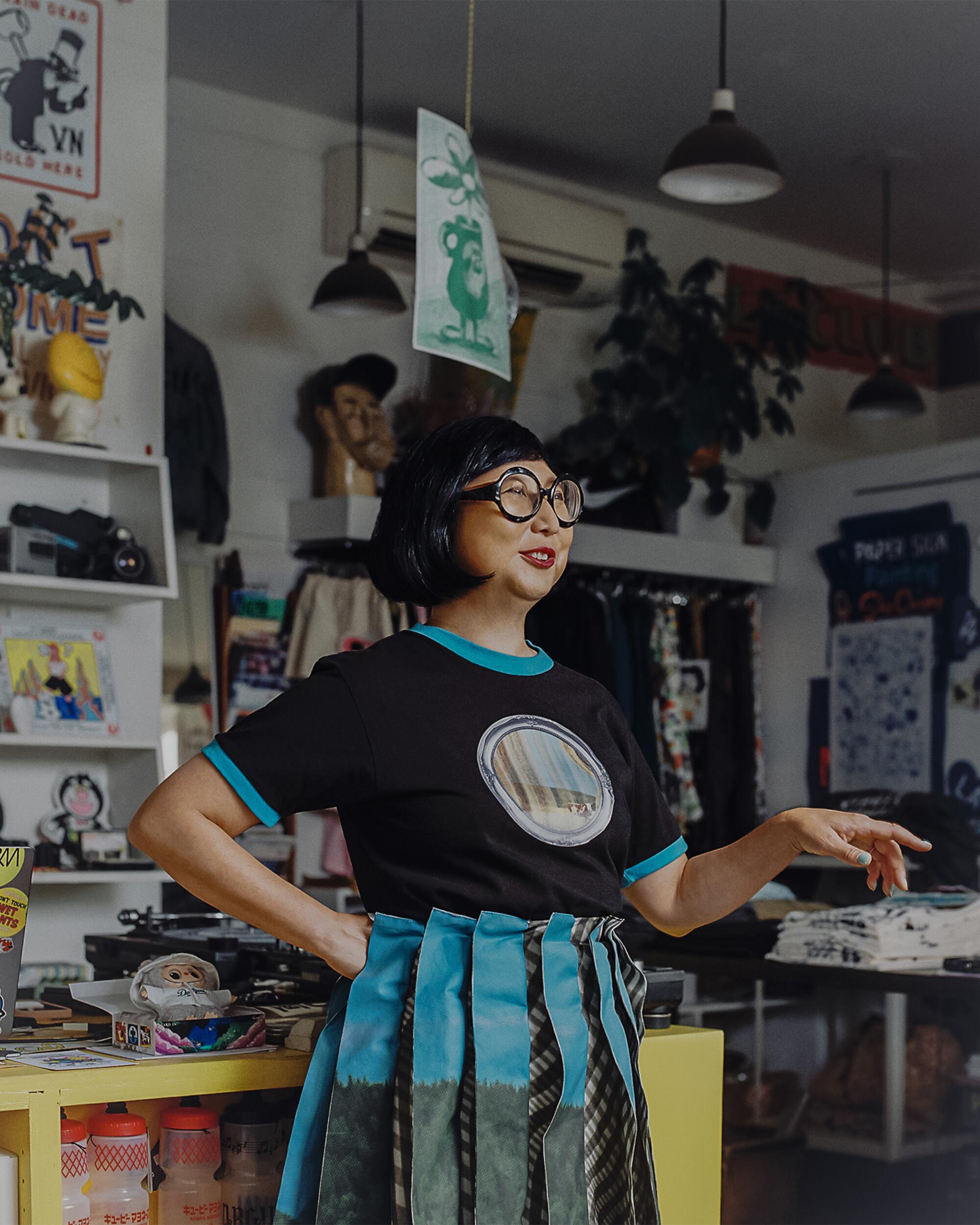 Shirley wears Leeann Huang t-shirt, skirt and shoes, We Love Colors tights, and l.a. Eyeworks glasses.