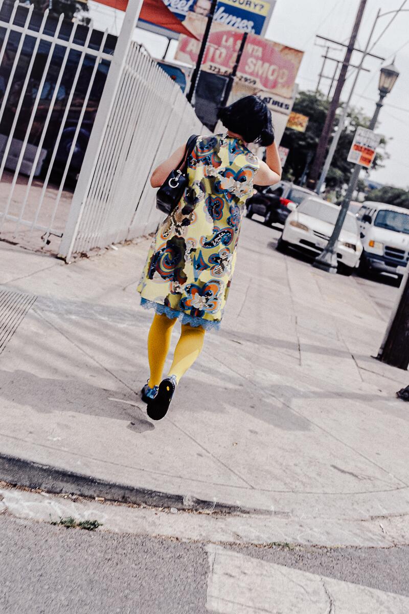 Shirley Kurata walking down the street.