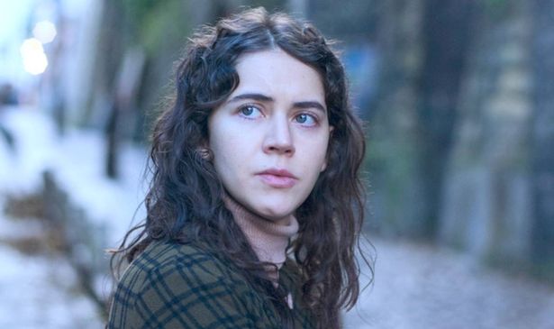 A woman with dark hair looks sad