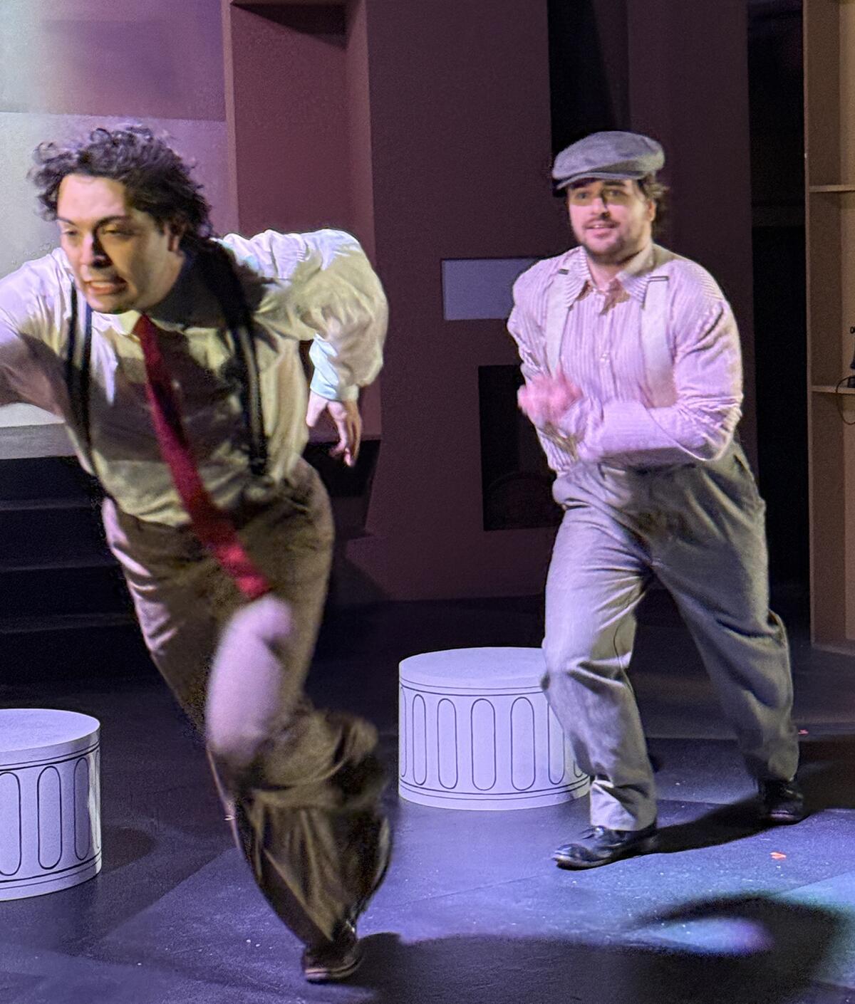 An actor chases another actor across a set.