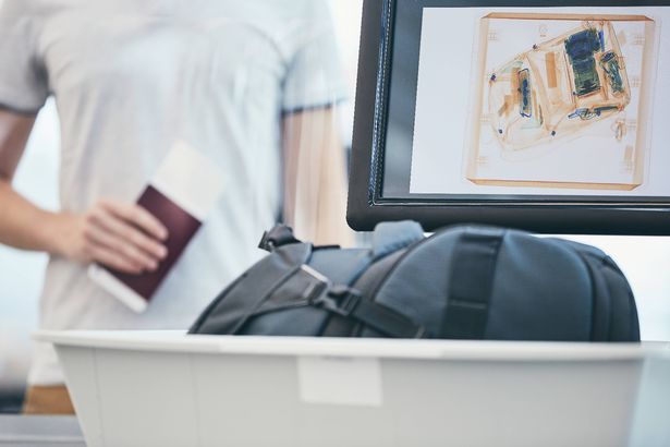 Checking hand luggage at the airport
