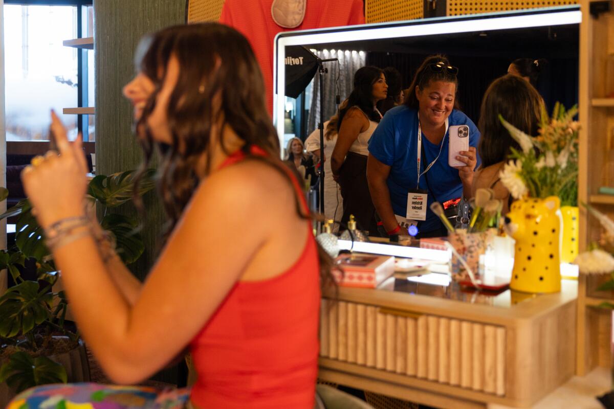 YouTube content creator Peja Anne, 15, makes a video with beauty products as her mom Kristin Roeder films during YouTube's Holiday House shopping event at Google Spruce Goose on Thursday, Oct. 16, 2025 in Playa Vista, CA.