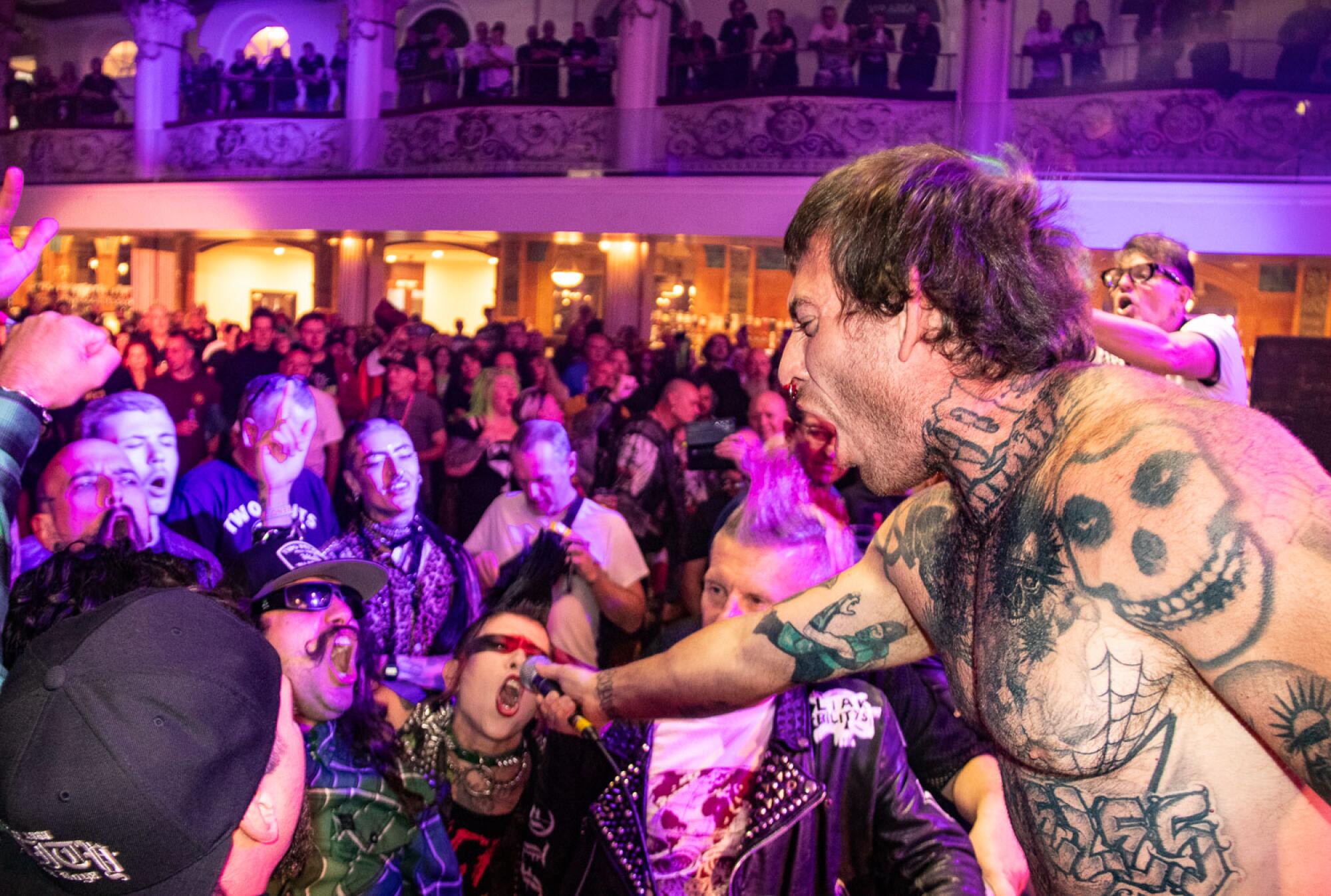 Knucklehead Tom of The KnuckleHeadz puts his mic in to the crowd at Rebellion punk rock festival.
