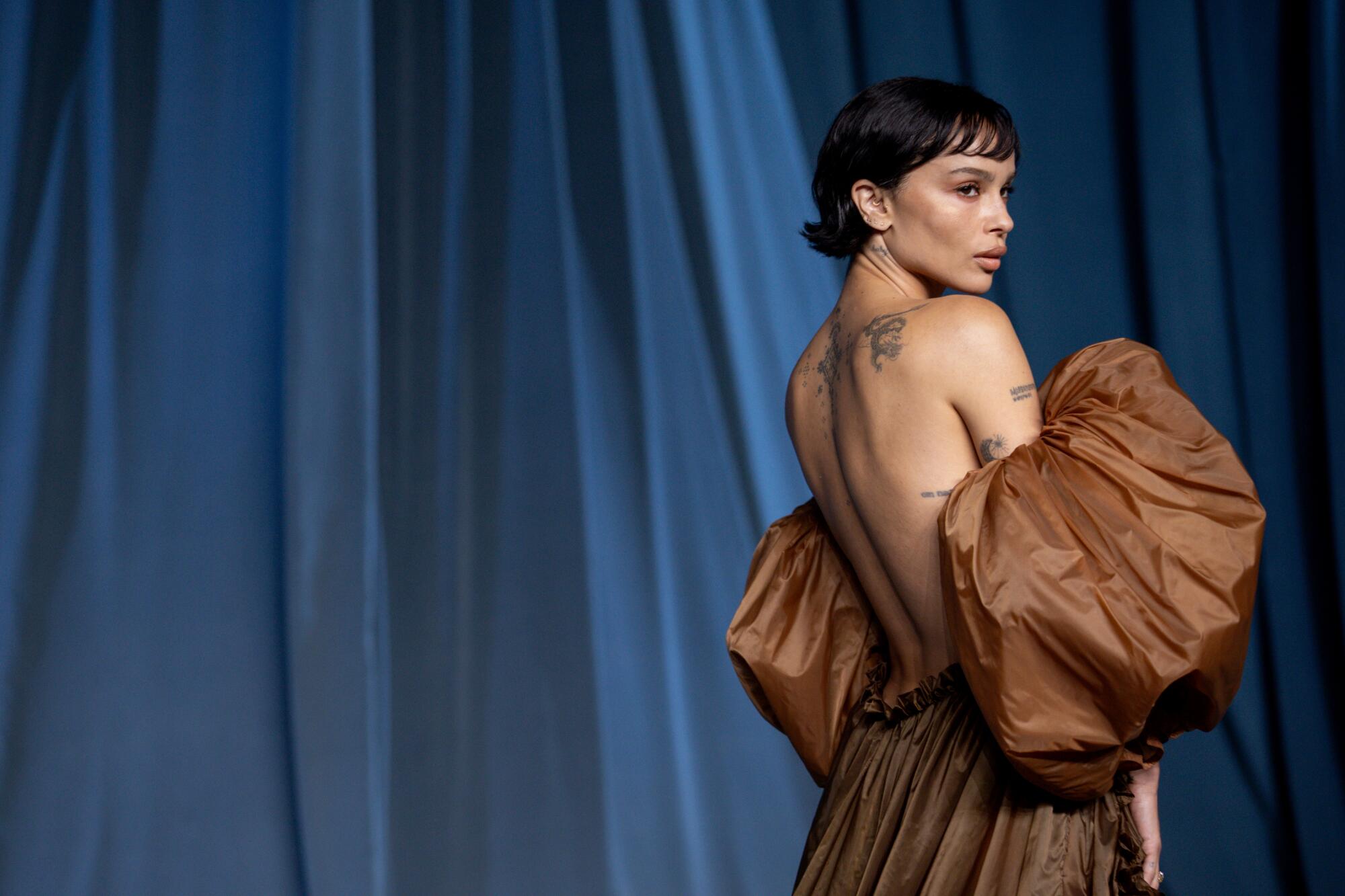 Zoe Kravitz looks to the side.