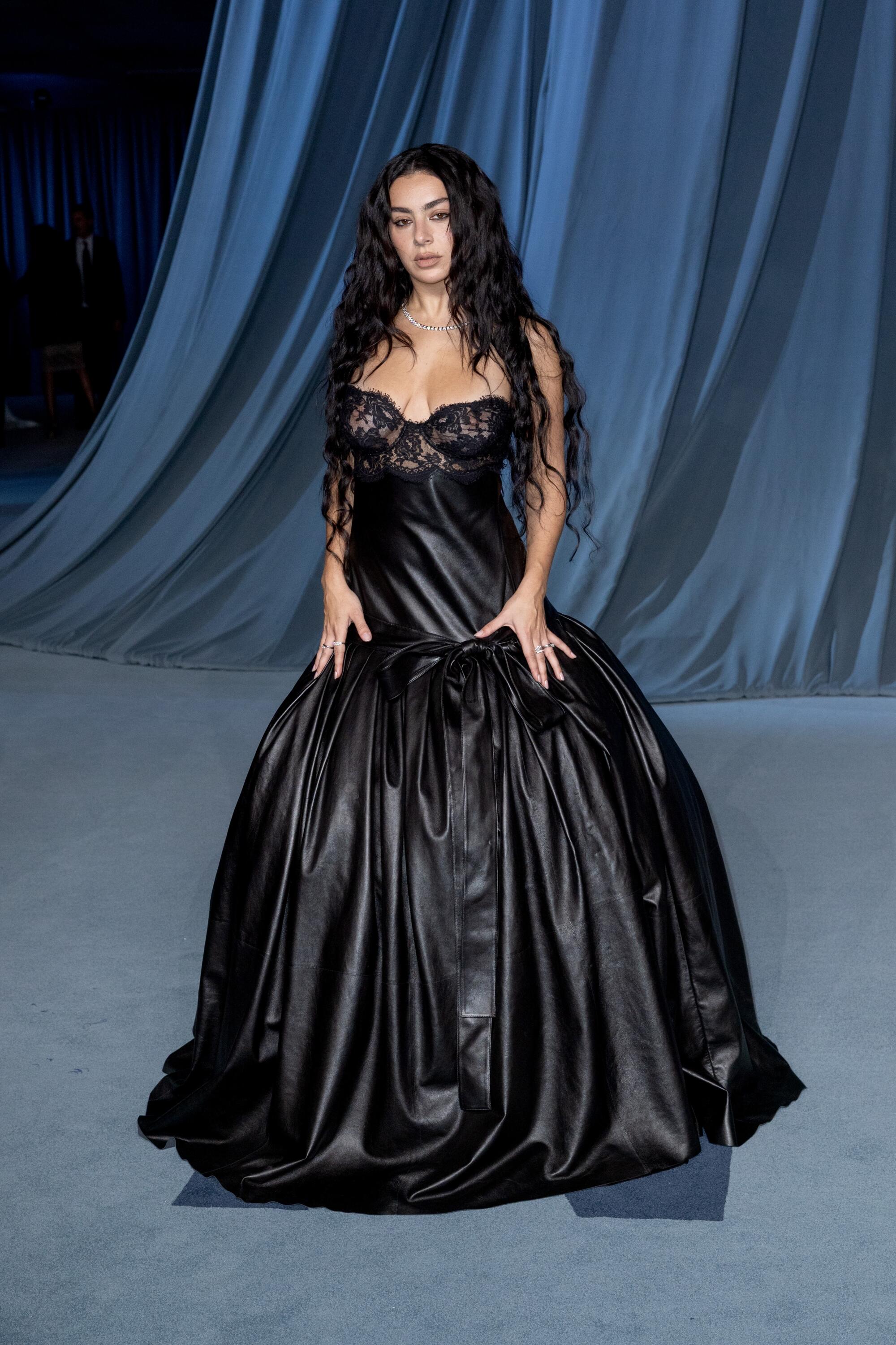 Charli XCX wears a black gown.