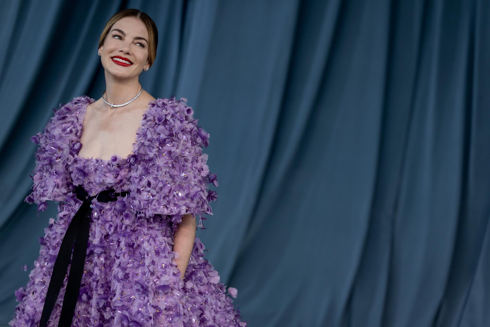 Michelle Monaghan wears a purple gown covered in florals.