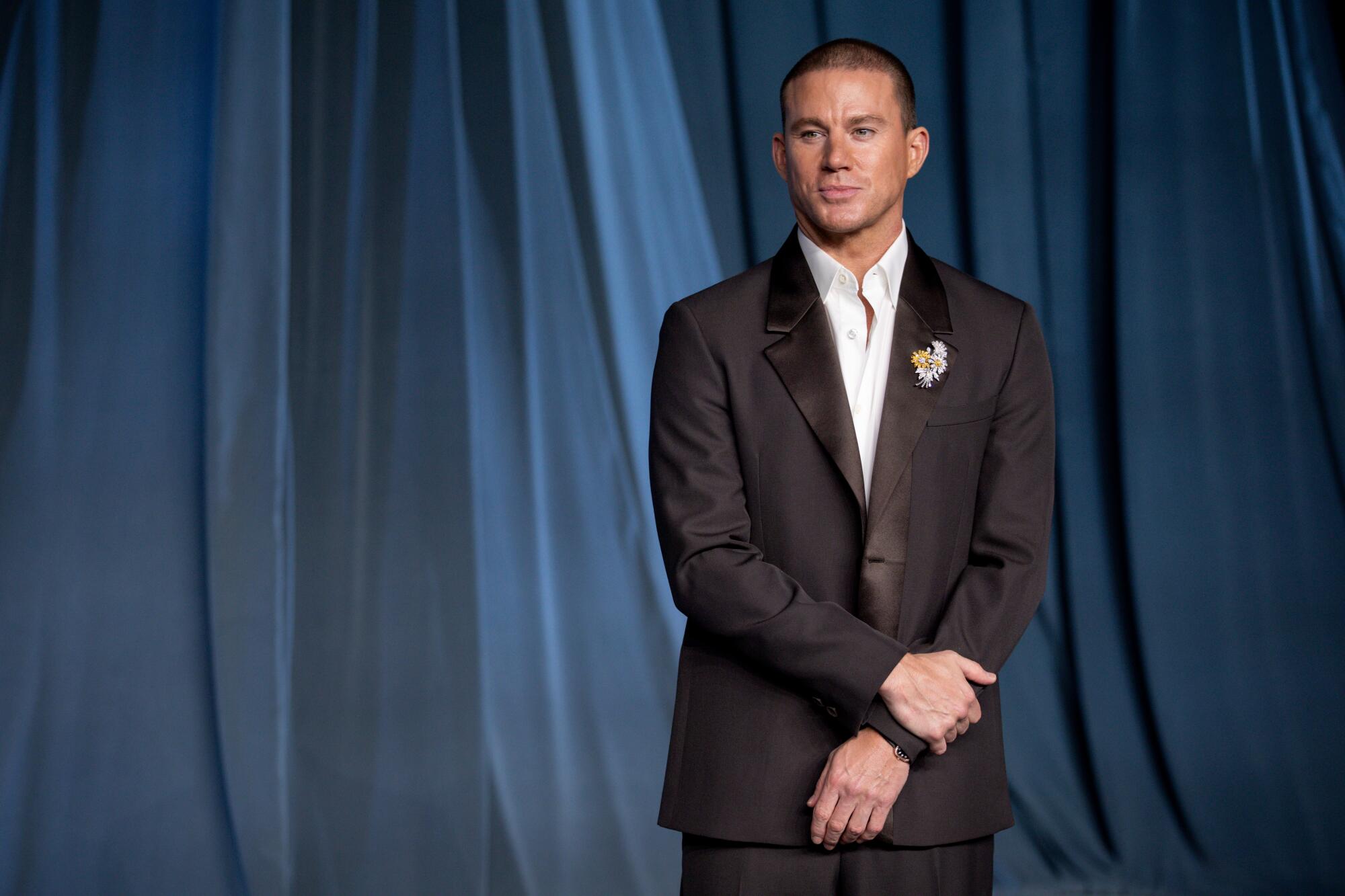 Channing Tatum wears a brown suit.