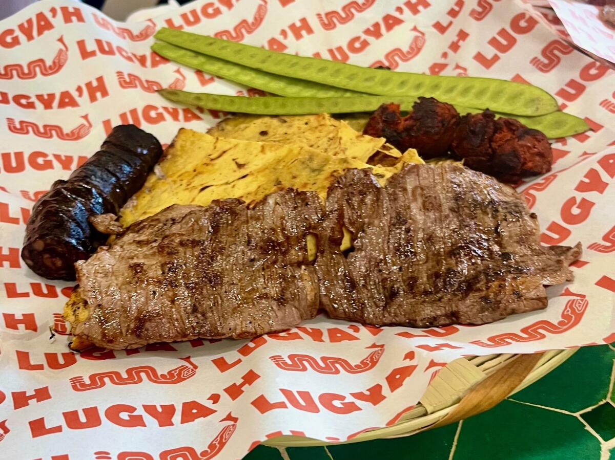 Oct 16, 2025-A slice of tlayuda with chorizo, tasajo and the blood sausage moronga from Lugya'h at L.A.'s Maydan Market.