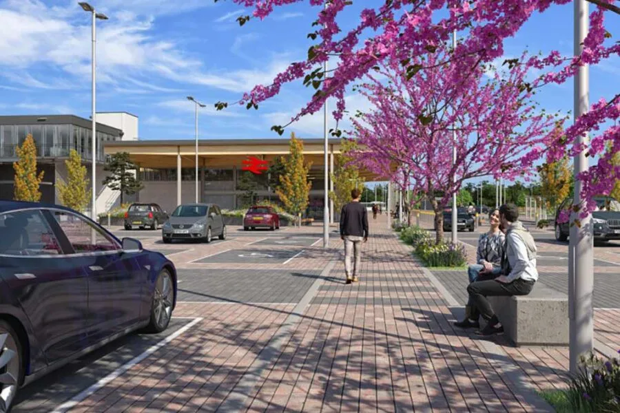 Illustration of a modernized train station with a parking lot and a red British Rail logo.