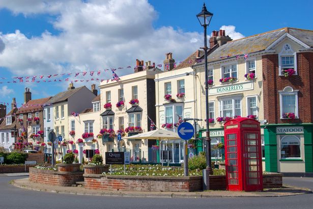 View of the central roundabout on Beach Street in Deal, Kent, England. A British phone booth can be seen as well as seaside pubs.