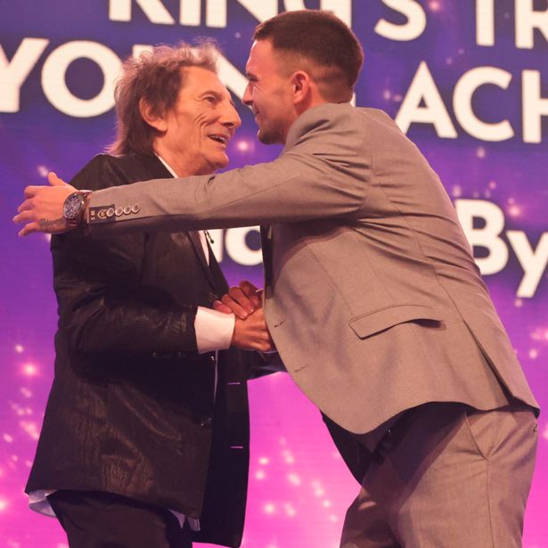 Kings Trust Young Achiever winner Harry Byrne is presented his award by Ronnie Wood.
