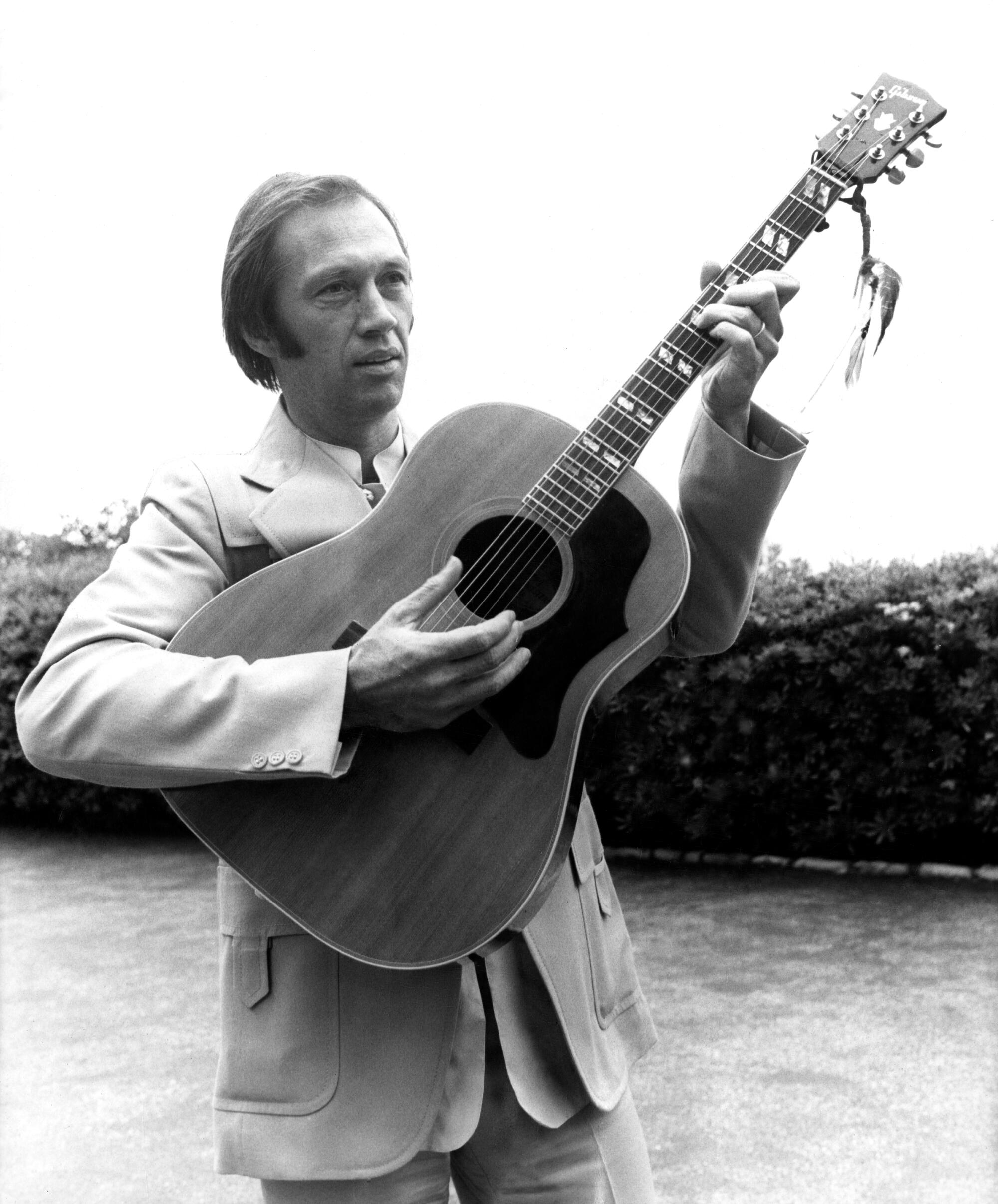 Actor David Carradine plays the guitar during the Cannes Film Festival in 1977.