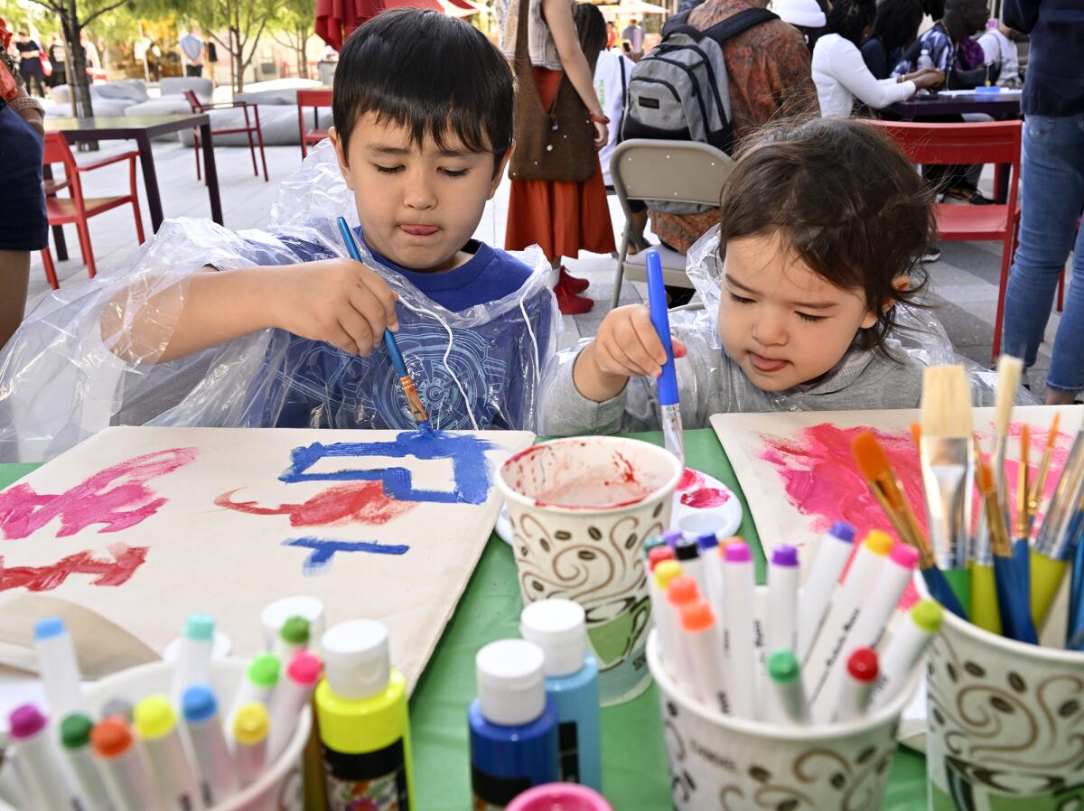 Two children painting.