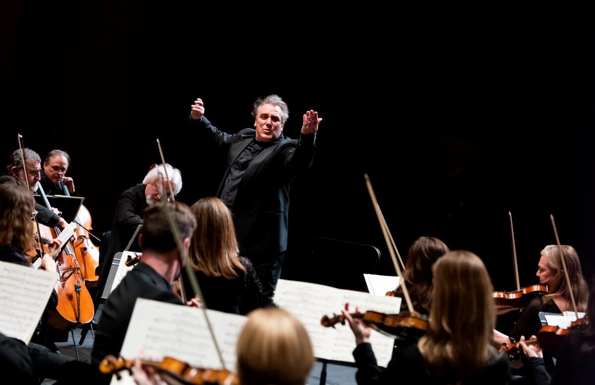 A conductor leading an orchestra.