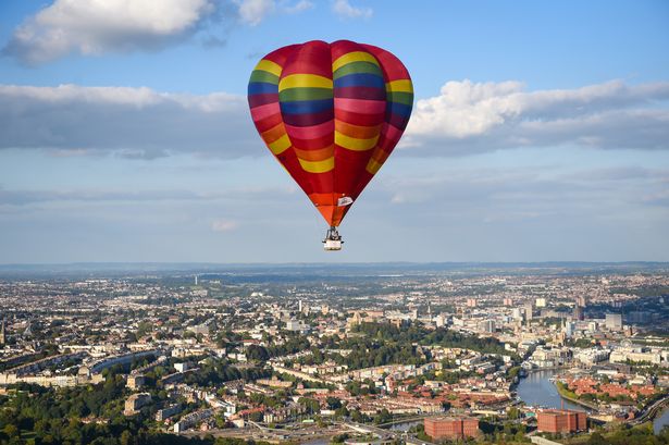  Balloons take to the sky as musician Jerome Gamble plays guitar to accompany the recorded music as it is played to the city below