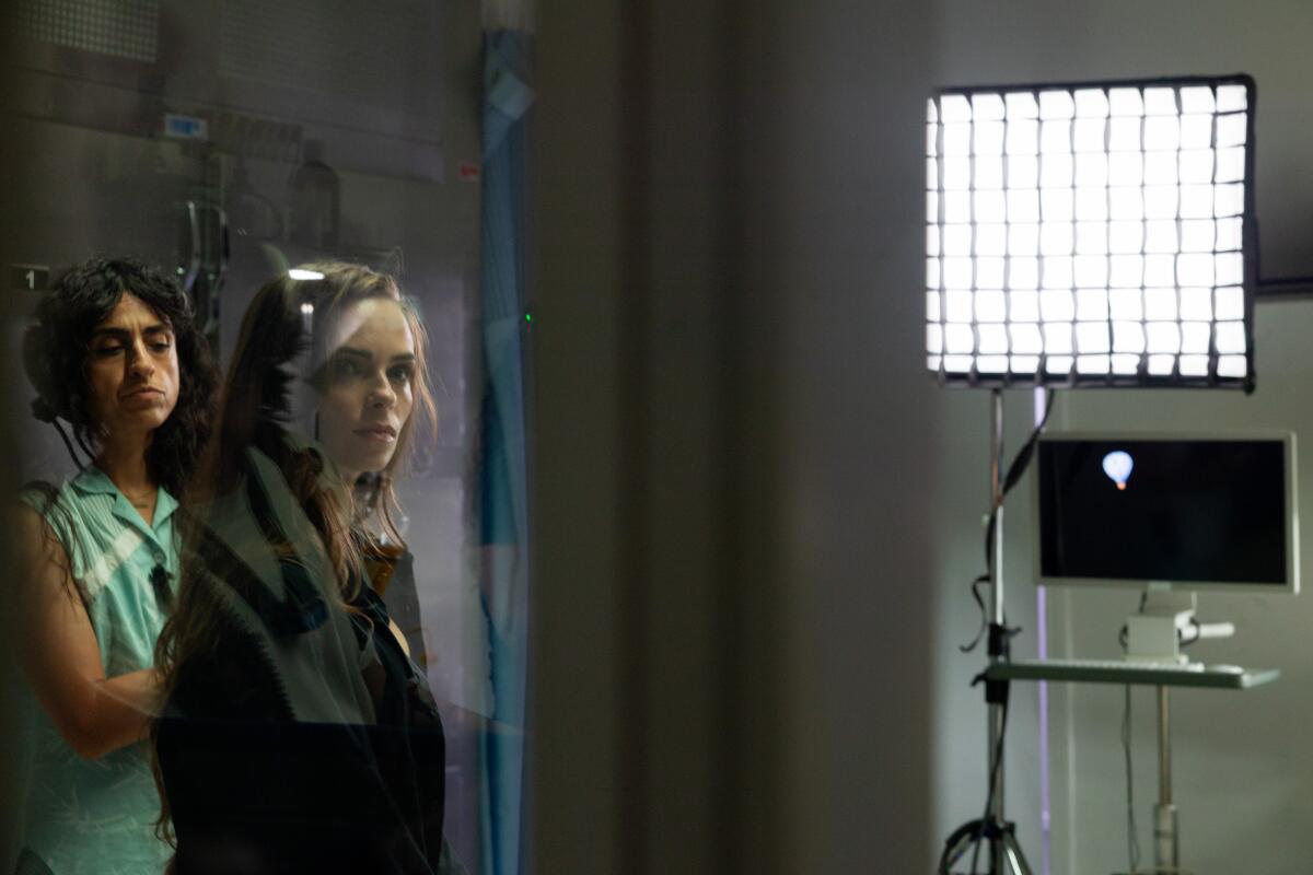 two people work on a film set near lighting