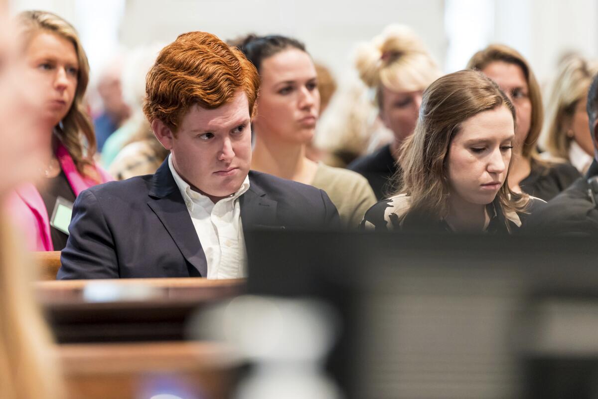 A photo of a man and a woman sitting next to each other in a courtroom.