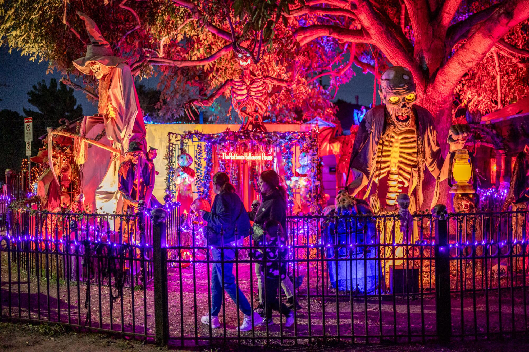 A haunted house with giant skeletons and spooky lights.
