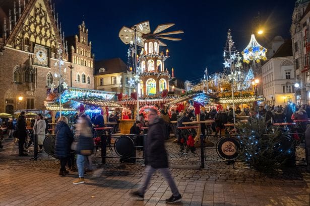 Visitors are seen as they visit the Christmas Markets at the Main Square in Wroclaw, Poland