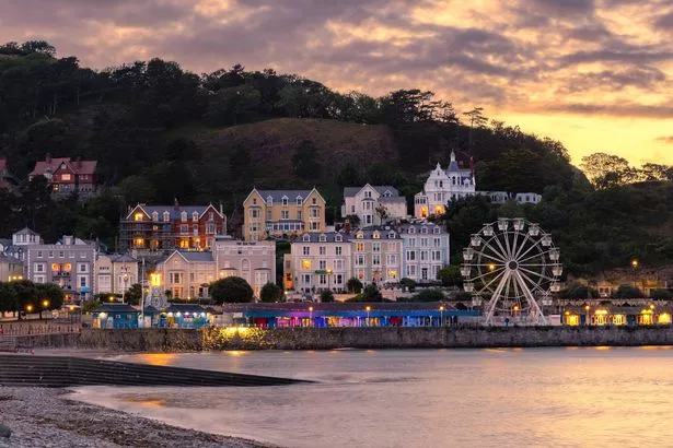 Llandudno, United Kingdom - July2, 2023 : Vibrant sunset over the popular seaside resort town in North Wales