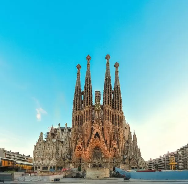 Majestic facade of Sagrada Familia basilica at early sunset in Barcelona