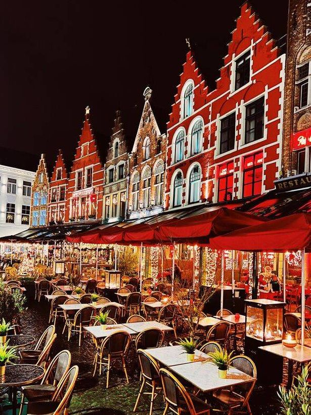 Cafes and restaurants at Market Square in Bruges at night, Belgium