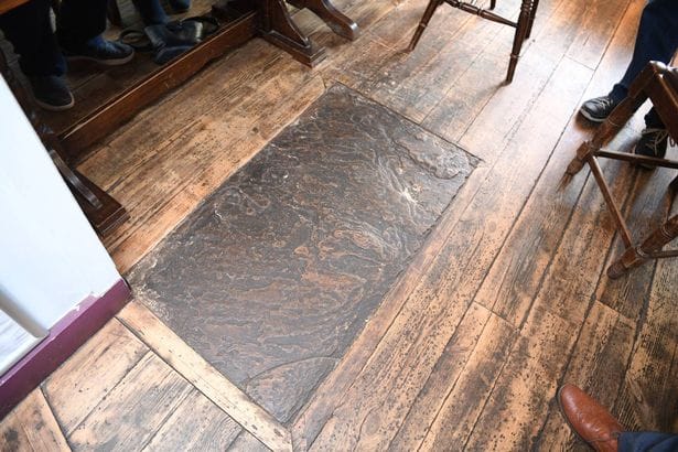 Juliet Tewsley's grave is marked by a simple stone slab
