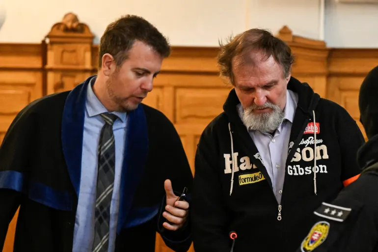 Juraj Cintula, accused of the 2024 attack on Slovak Prime Minister Robert Fico, listens to his lawyer Namir Alyasry, after the verdict, on the last day of his trial, at the Specialised Criminal Court in Banska Bystrica, Slovakia, October 21, 2025. REUTERS/Radovan Stoklasa