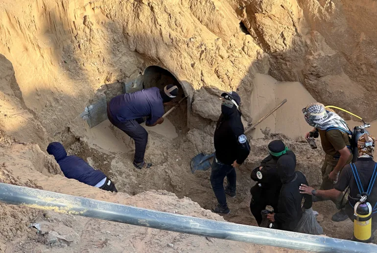 People work at a site where searches for deceased hostages, kidnapped by Hamas during the October 7, 2023, attack on Israel, are underway, amid a ceasefire between Israel and Hamas, in Khan Younis, southern Gaza Strip, October 28, 2025. REUTERS/Haseeb Alwazeer