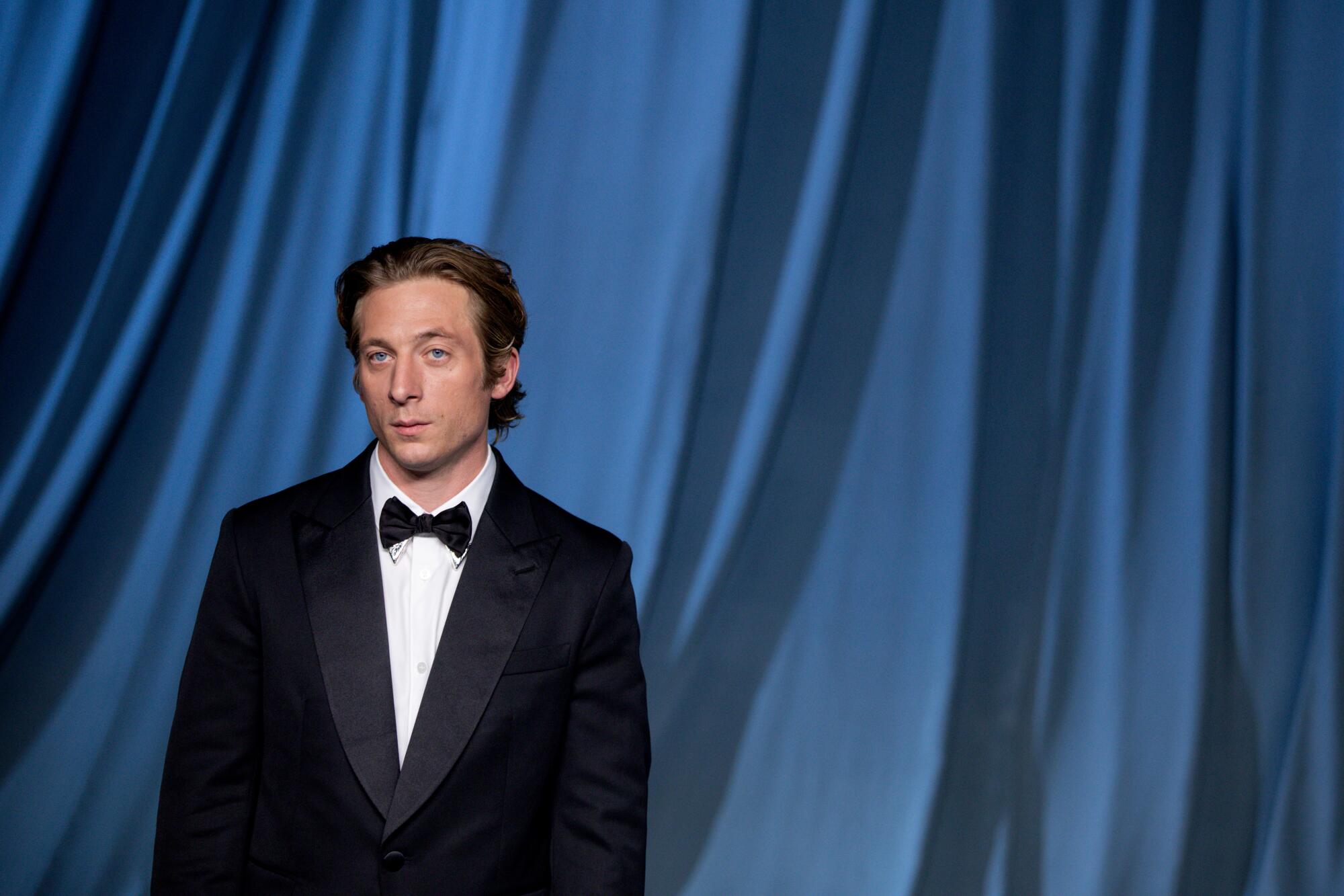 Jeremy Allen White poses in a tuxedo.