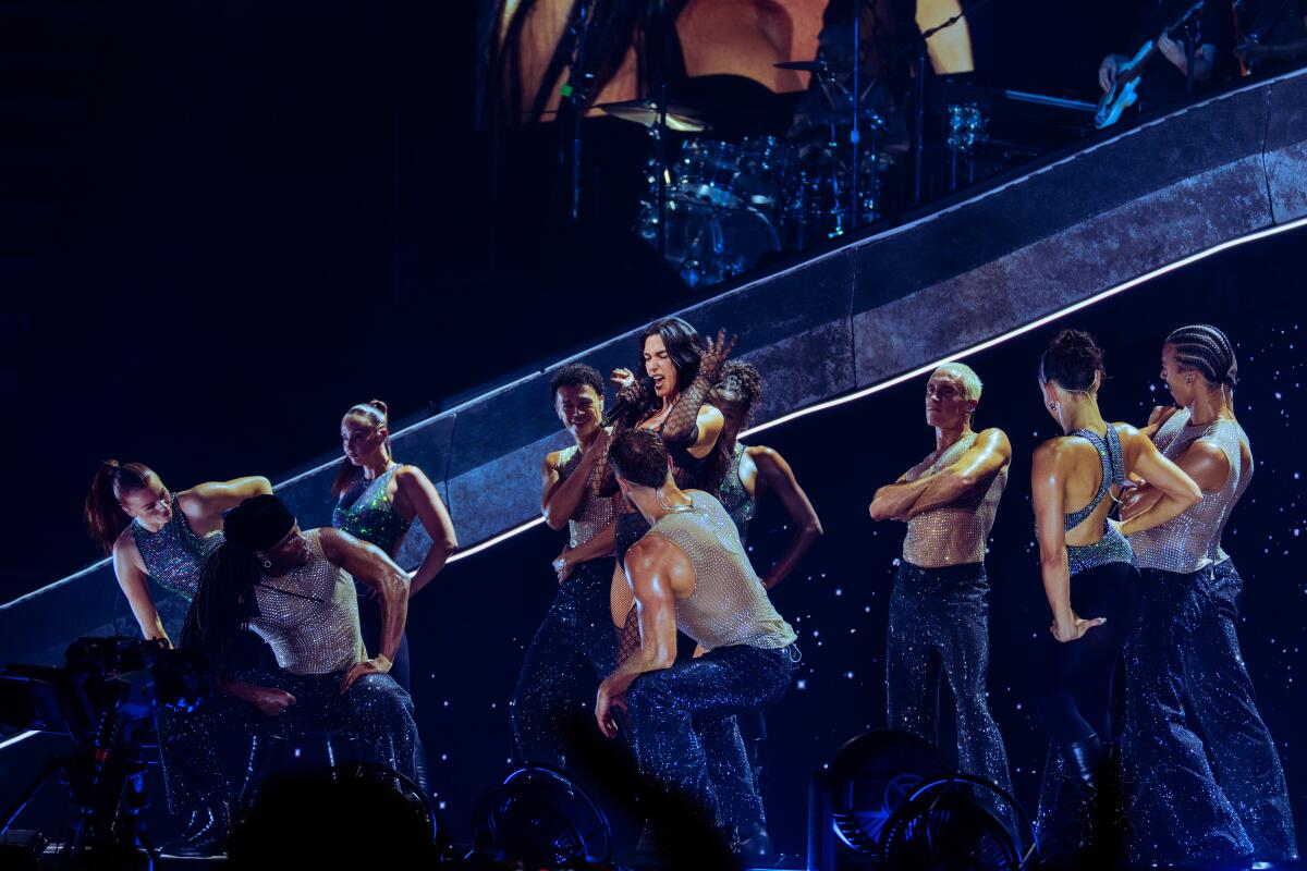 Dua Lipa sings and dances with backup performers