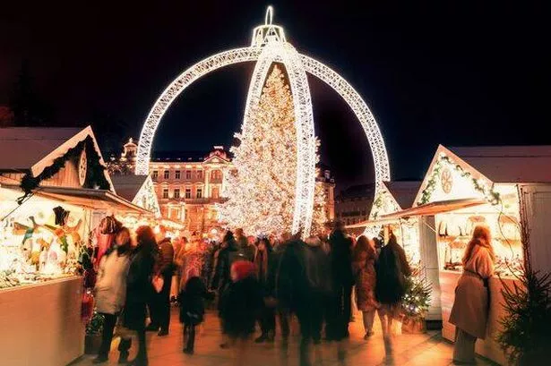 Vilnius, Lithuania - 30th november, 2024: motion blur people visitors in motion shopping on Xmas market sightseeing beautiful Xmas tree in city VVilni
