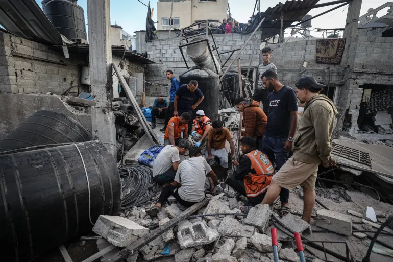 Civil defense teams and Palestinians are conducting search and rescue operations in collapsed buildings at the Zeitoun neighborhood after Israeli forces attacked