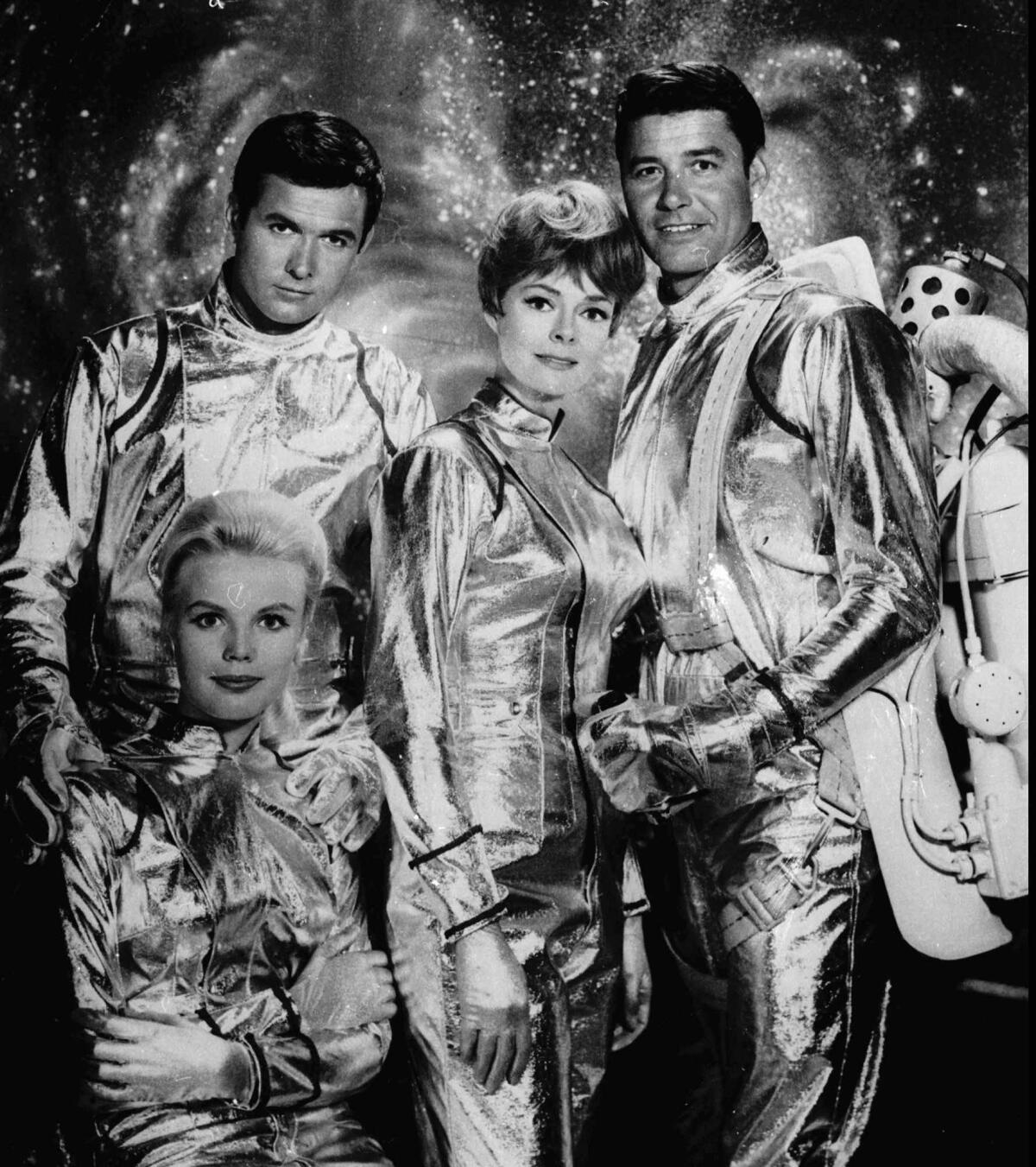 Actors in the TV show "Lost in Space" pose in costume