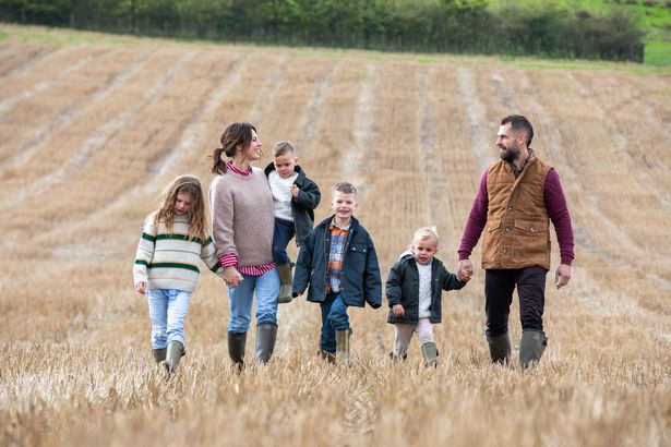 Kelvin and Liz Fletcher with their kids on their Cheshire farm