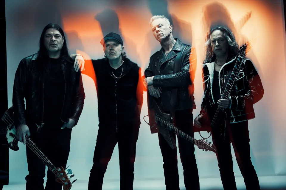The four members of Metallica posing with their instruments.