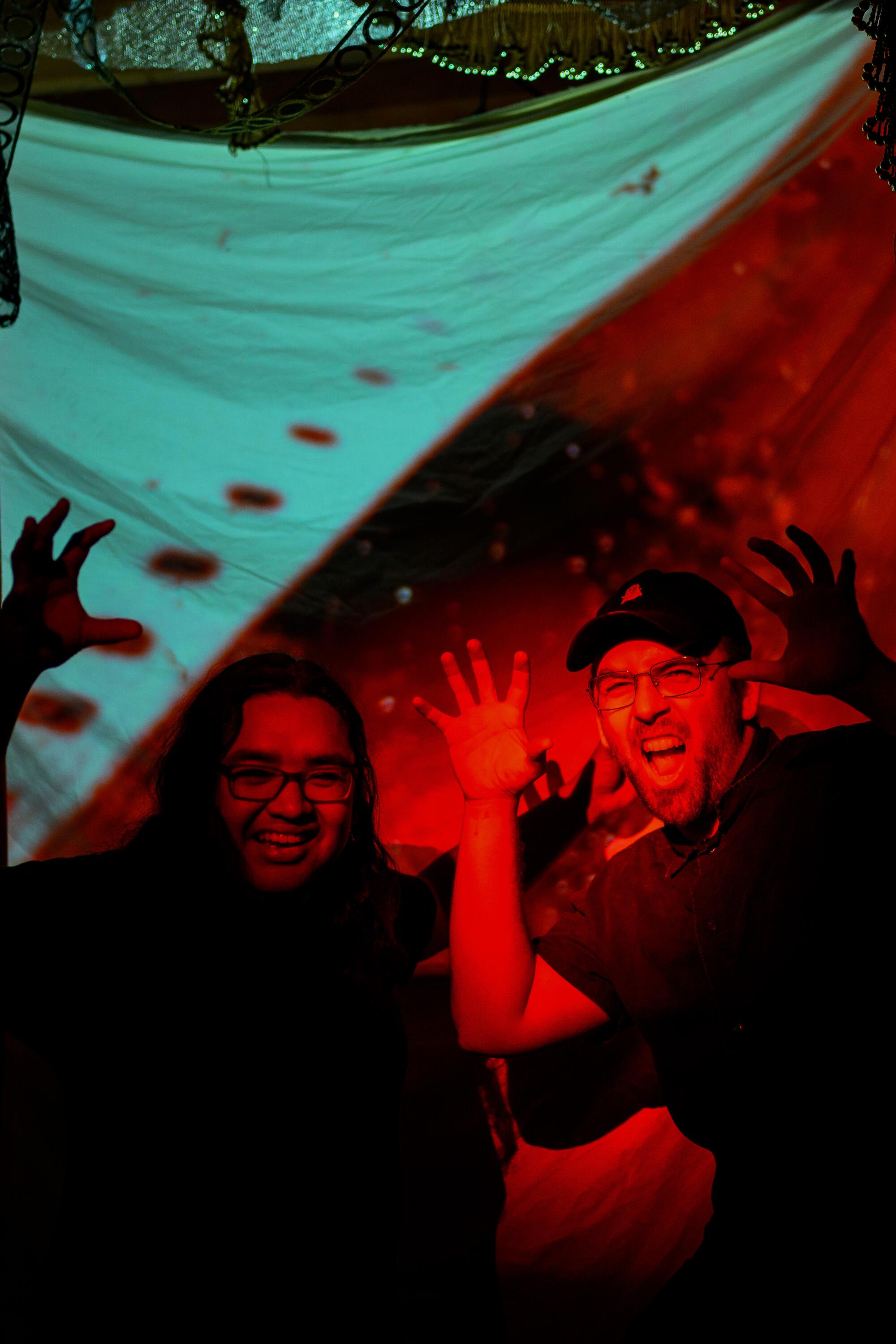 Two people making scary faces at the camera.