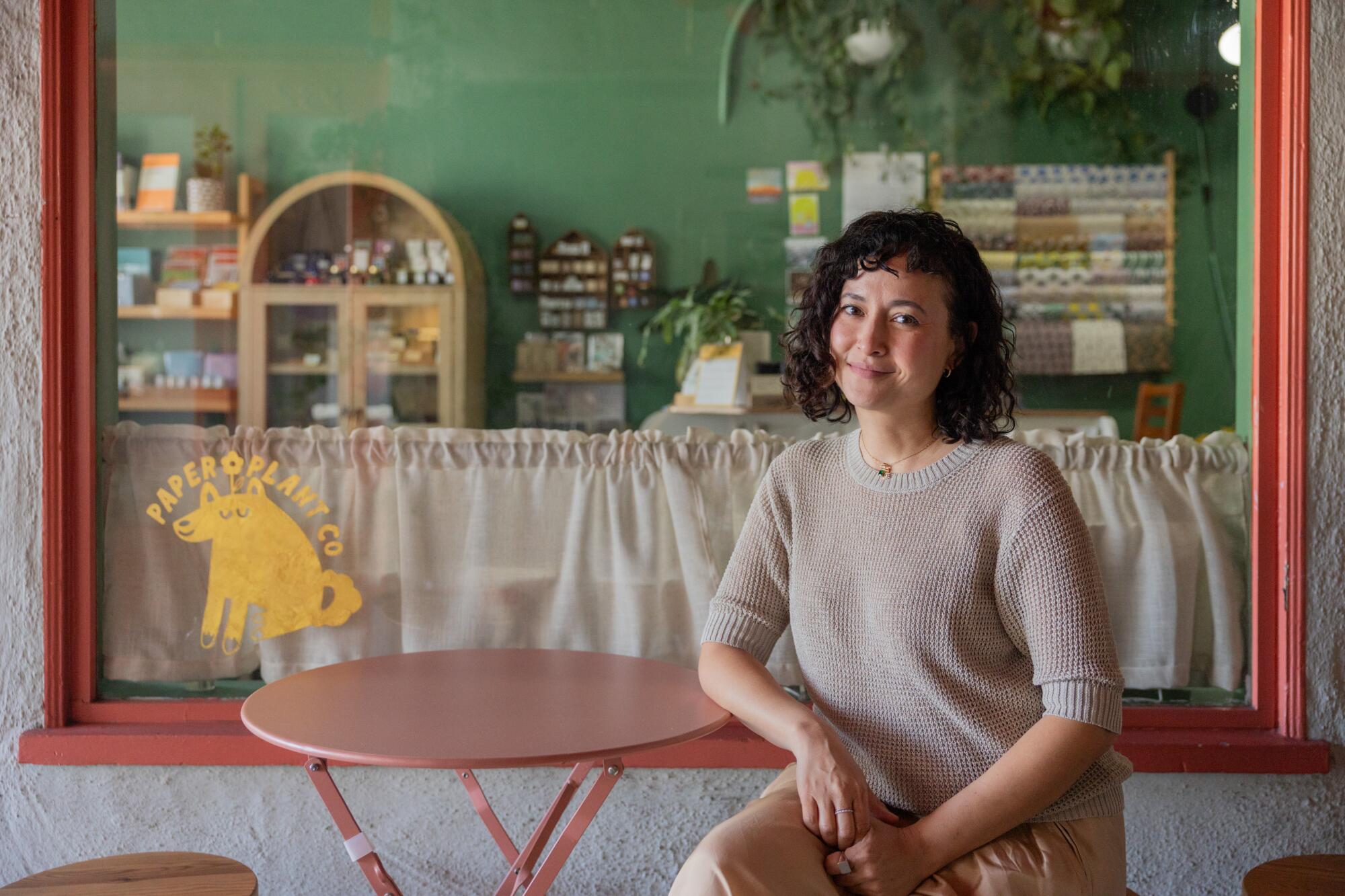 Friedia Niimura sits for a portrait outside her shop Paper Plant Co. 