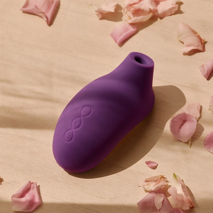 Purple clitoral stimulator with rose petals.