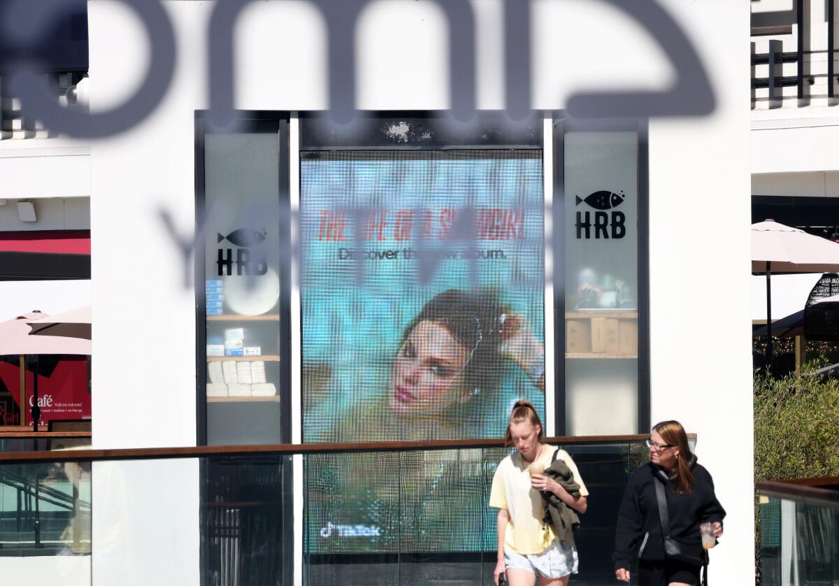 Taylor Swift's "The Life of a Showgirl" is advertised outside of an AMC theater.