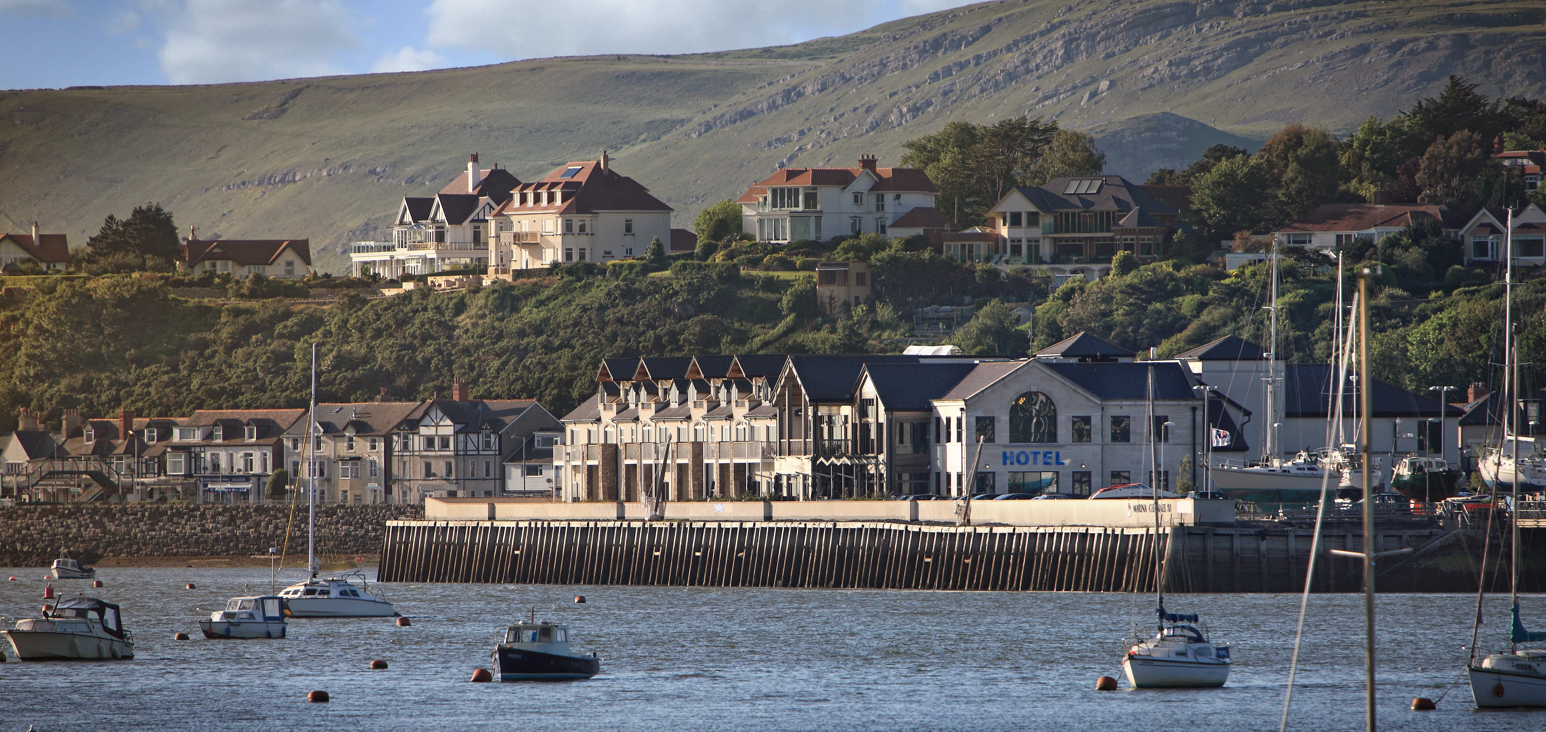 Quay Hotel and Spa overlooking a harbor.