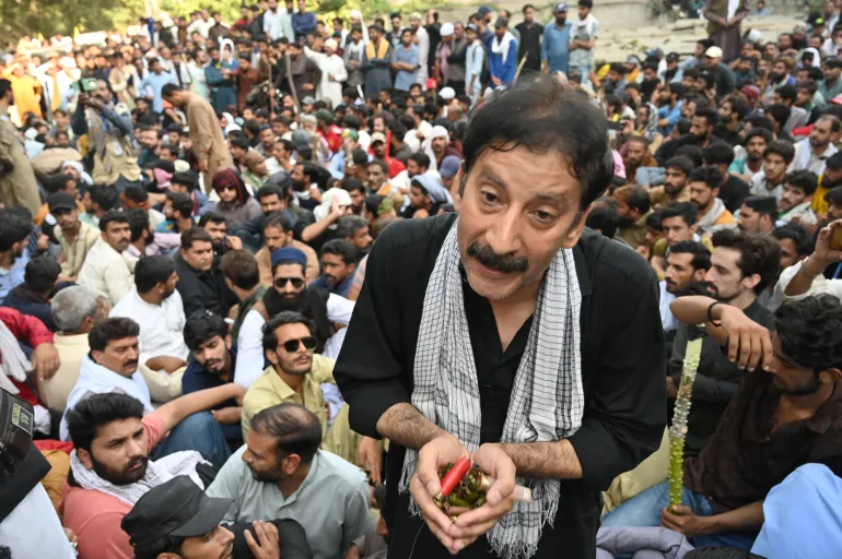 TOPSHOT - Shaukat Nawaz Mir, a leader of the Awami Action Committee (AAC) shows bullets allegedly fired by police during a demonstration in Muzaffarabad, capital of Pakistan-administered Kashmir on October 1, 2025, demanding structural reforms and political and economic rights.