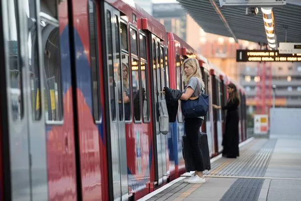 Commuters board Docklands Light Railway (DLR) train at East India station in London, U.K., on Monday, Aug. 14, 2017. The Docklands Light Railway, a low-capacity rail system connecting the City of London to the Docklands area that carries 122 million passengers a year, began operating on Aug. 31, 1987. Photographer: Simon Dawson/Bloomberg via Getty Images