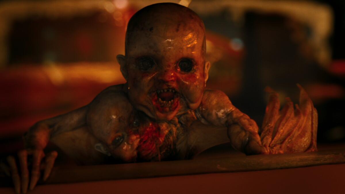 A demonic baby with no eyes, pointy teeth and bat wing arms.